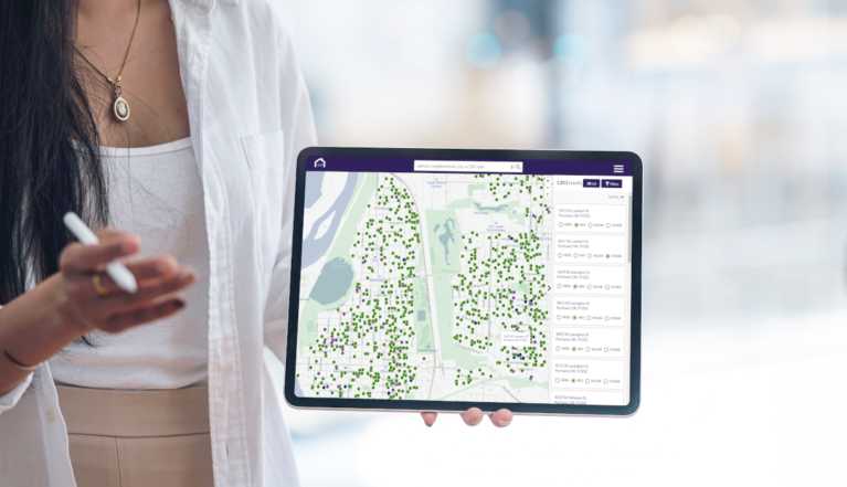 woman holds green building registry application on tablet